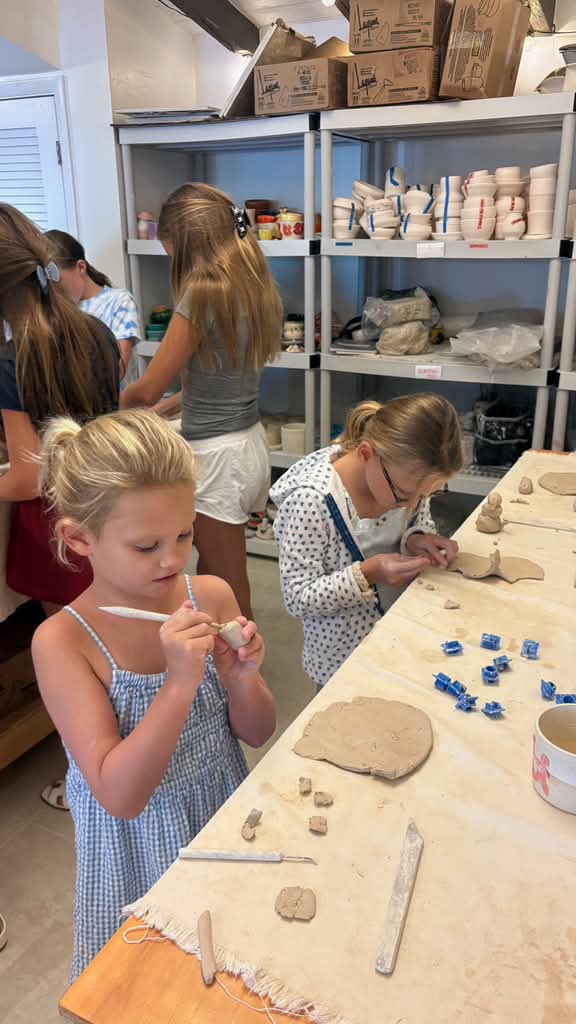 Kids sculpting and painting their pieces
