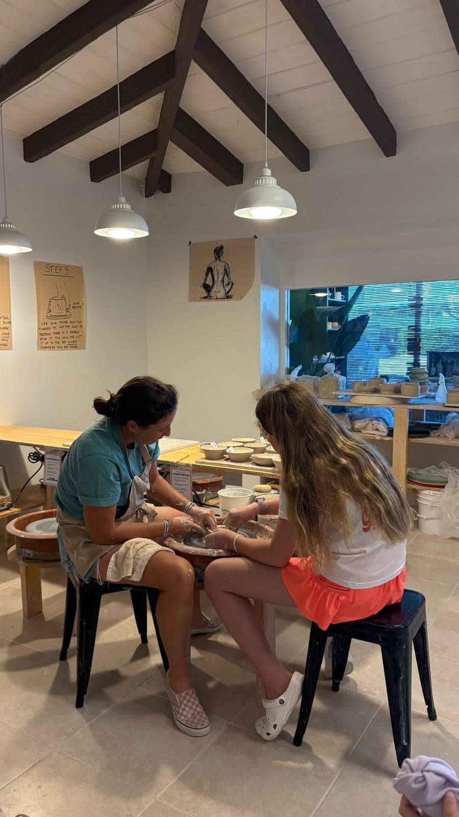 Shaping a bowl together on the wheel