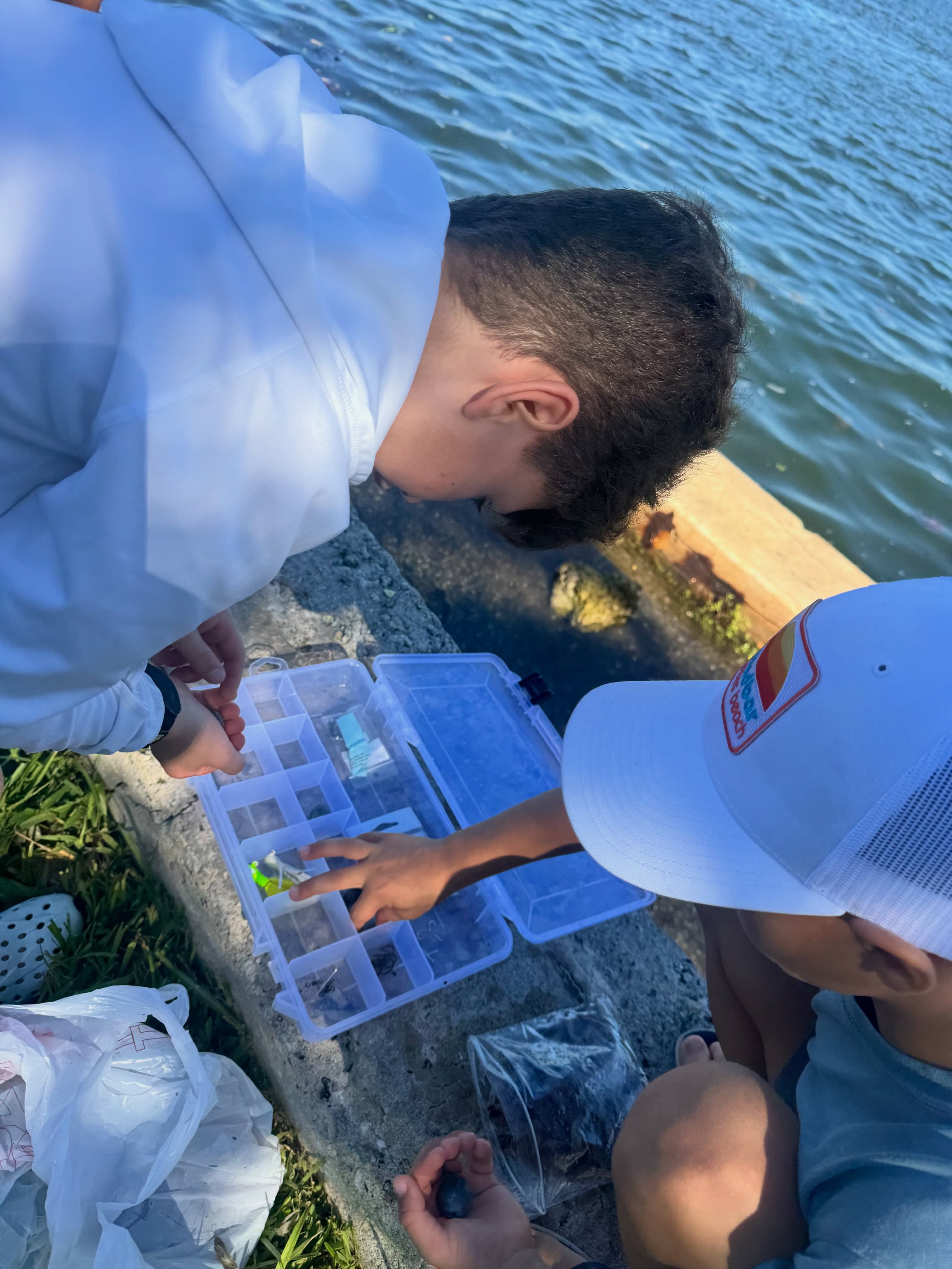 Kids learning to cast by the water