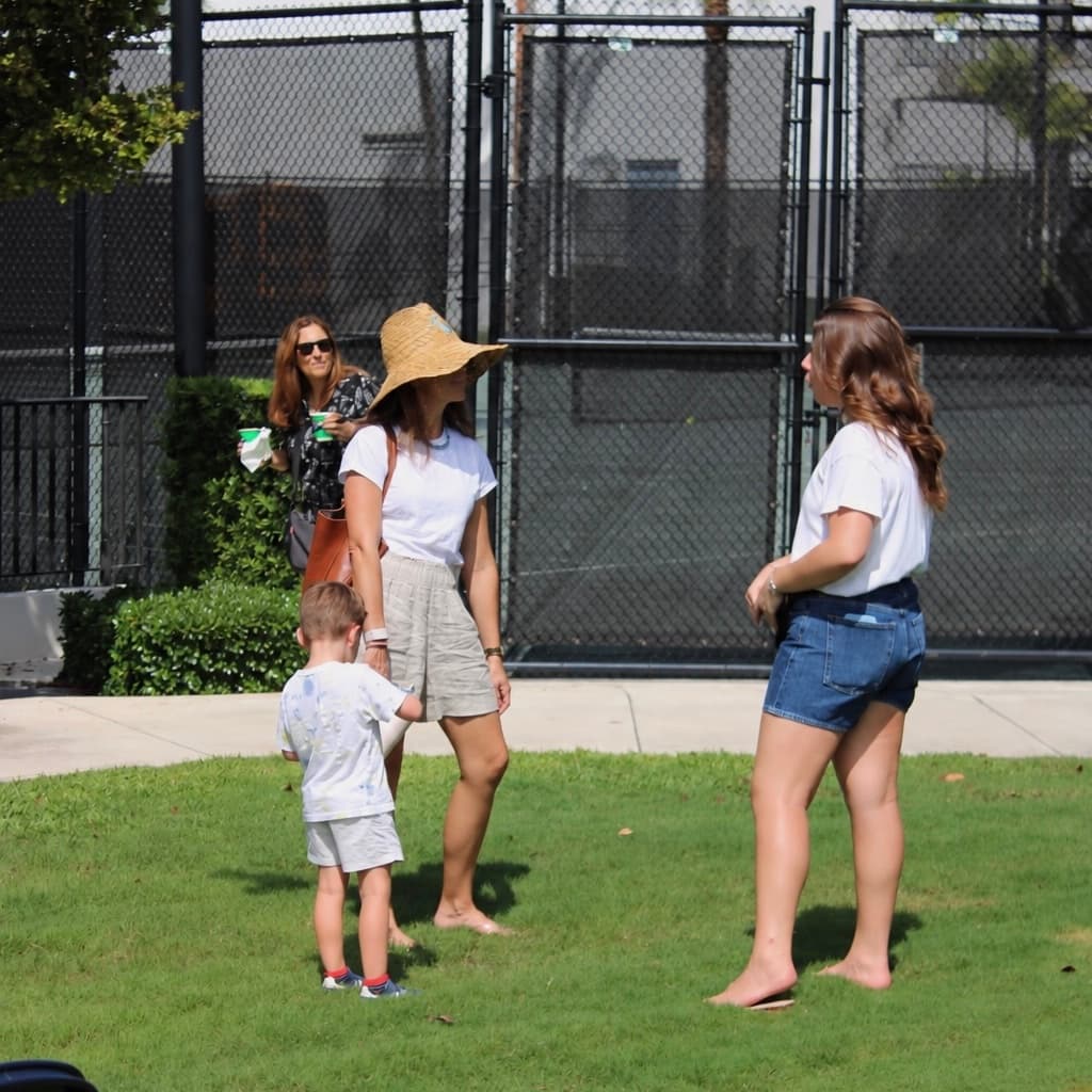 Parents and kids chatting on the lawn