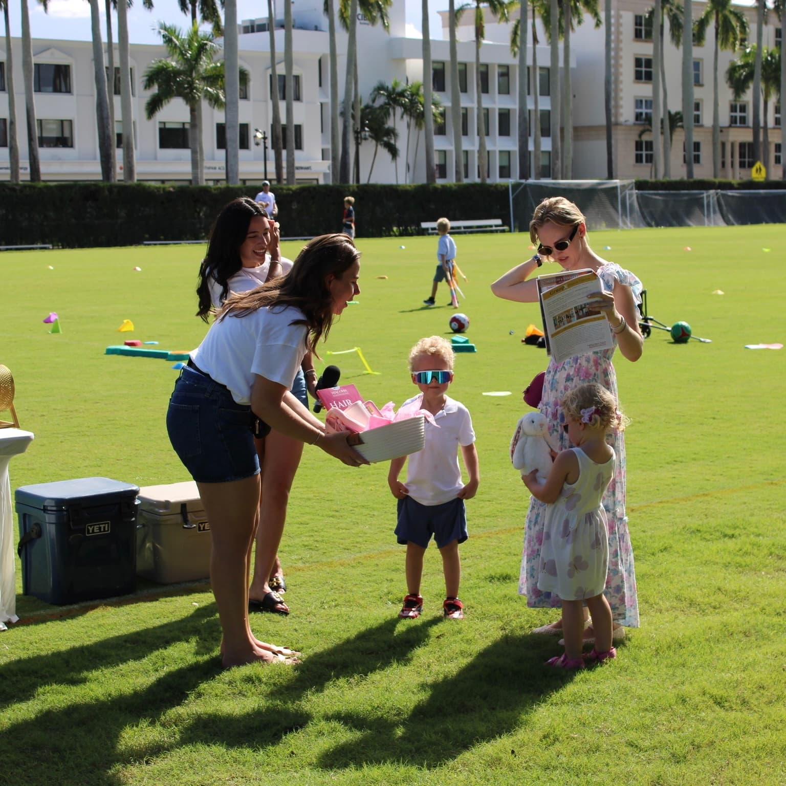 The Village team handing out gift baskets on the field