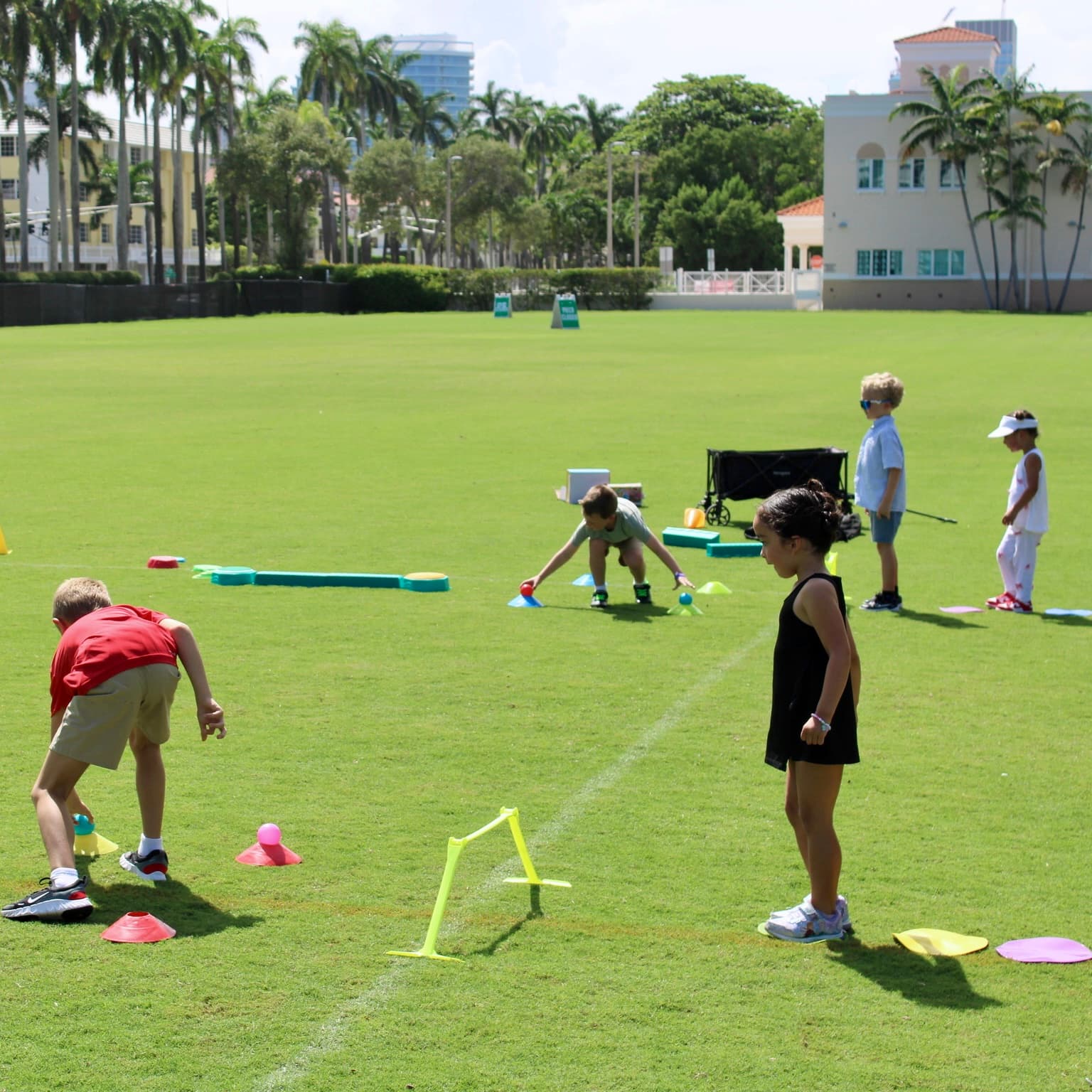 Kids playing an obstacle course game on the grass