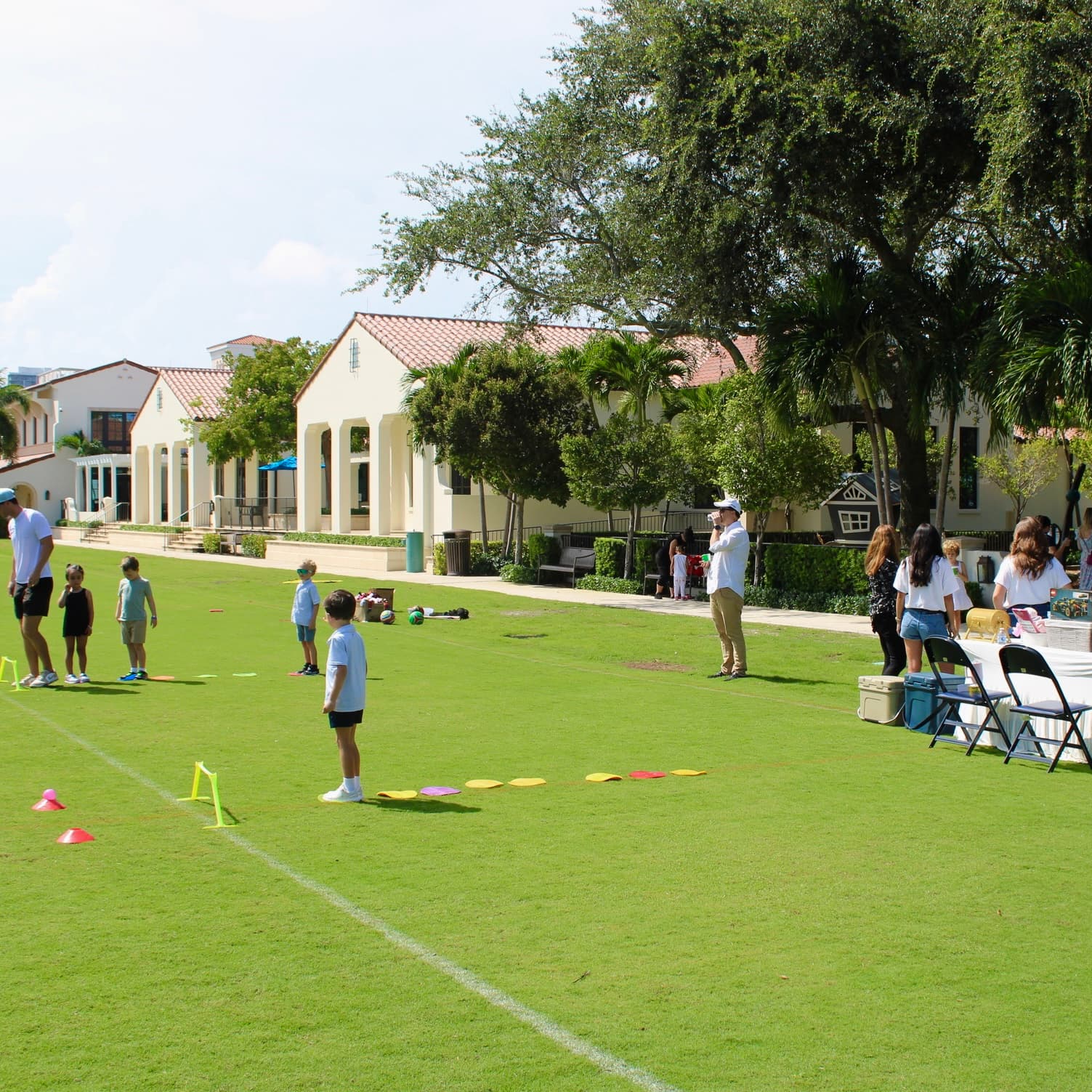 Families gathered on the field at a Village event
